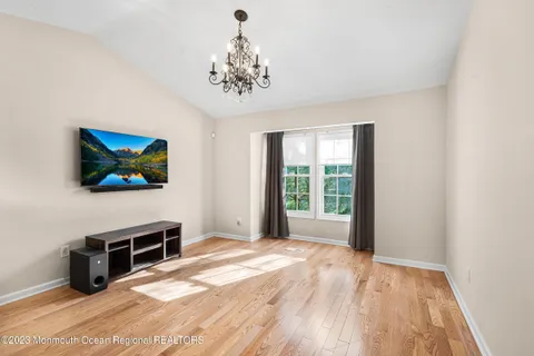 a view of a livingroom with a furniture wooden floor and window