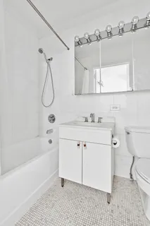 a bathroom with a sink a toilet and bathtub