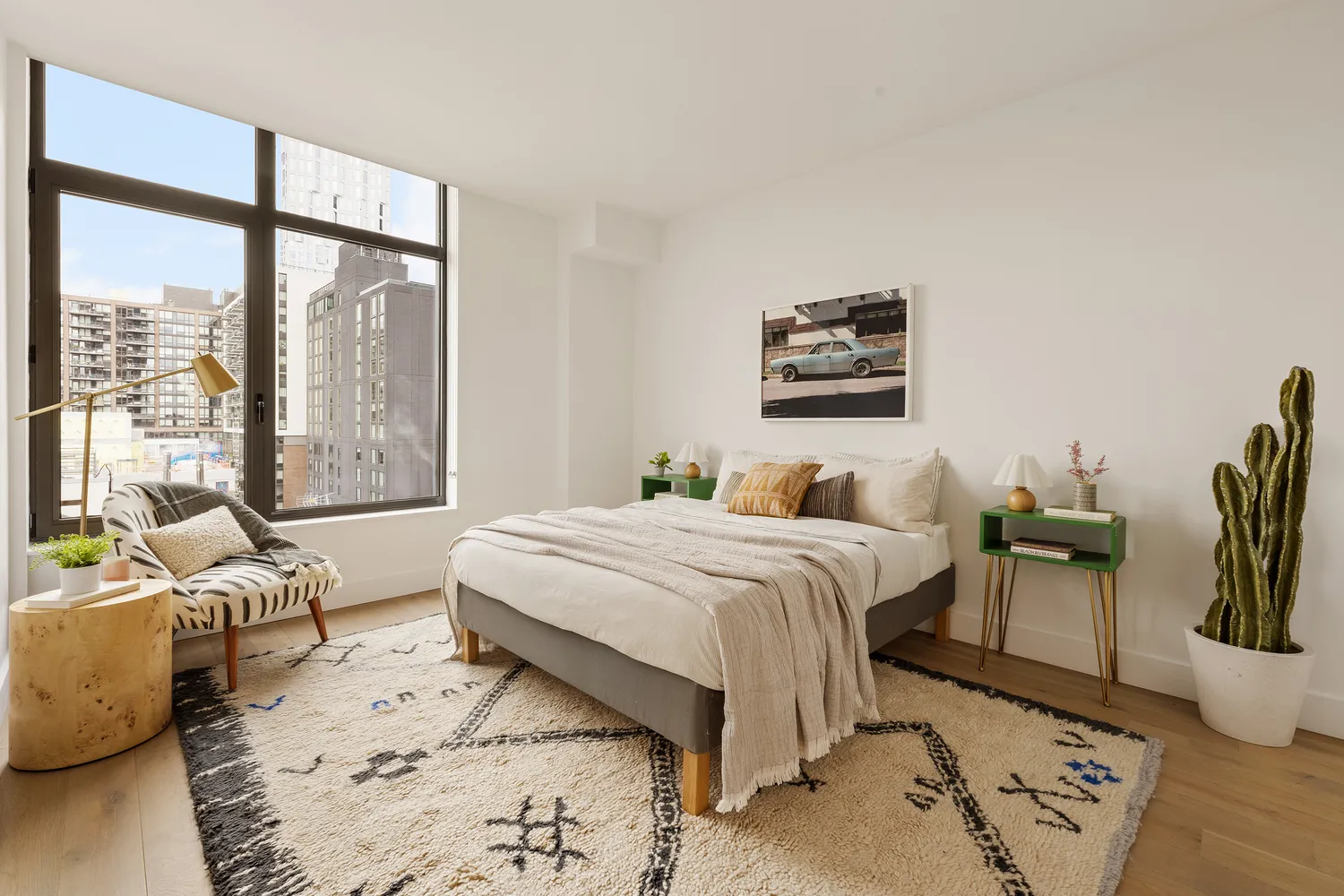 a bedroom with furniture and a large window