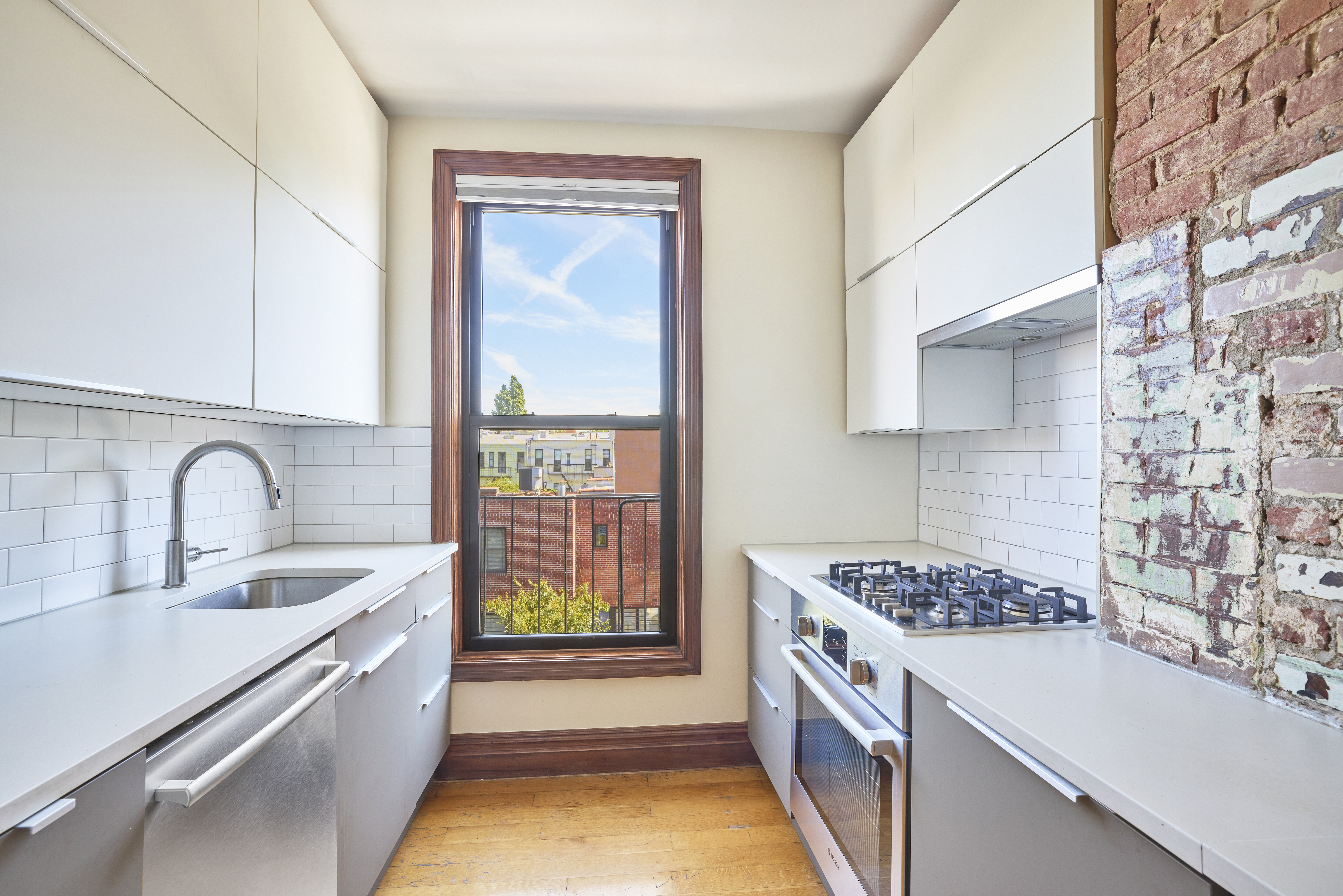 1702 8th Avenue, Unit 3 Brooklyn, NY 11215 - Photo 4 of 15 a kitchen with a sink stove and cabinets