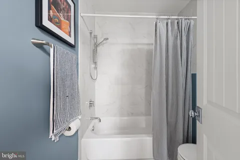 a bathroom with a shower and a tub