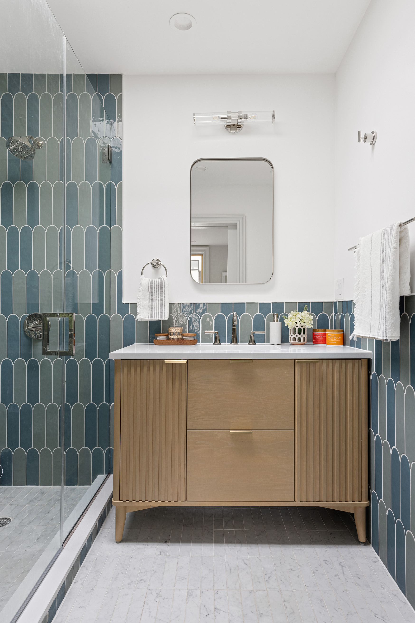 363 Warren Street Brooklyn, NY 11201 - Photo 14 of 23 a bathroom with a granite countertop sink a mirror and shower