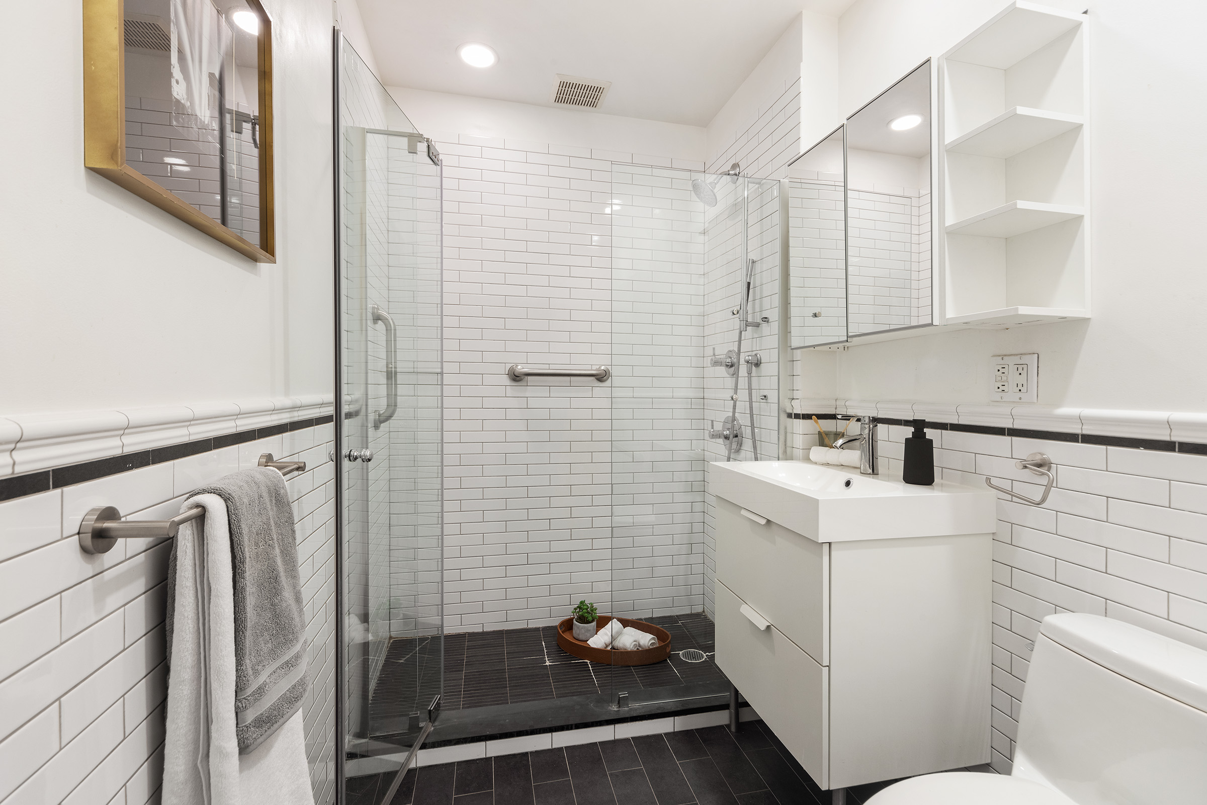 10 Leonard Street, Unit 6N Manhattan, NY 10013 - Photo 6 of 12 a bathroom with a sink a toilet and shower