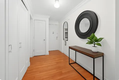 a bedroom with a bed and a potted plant
