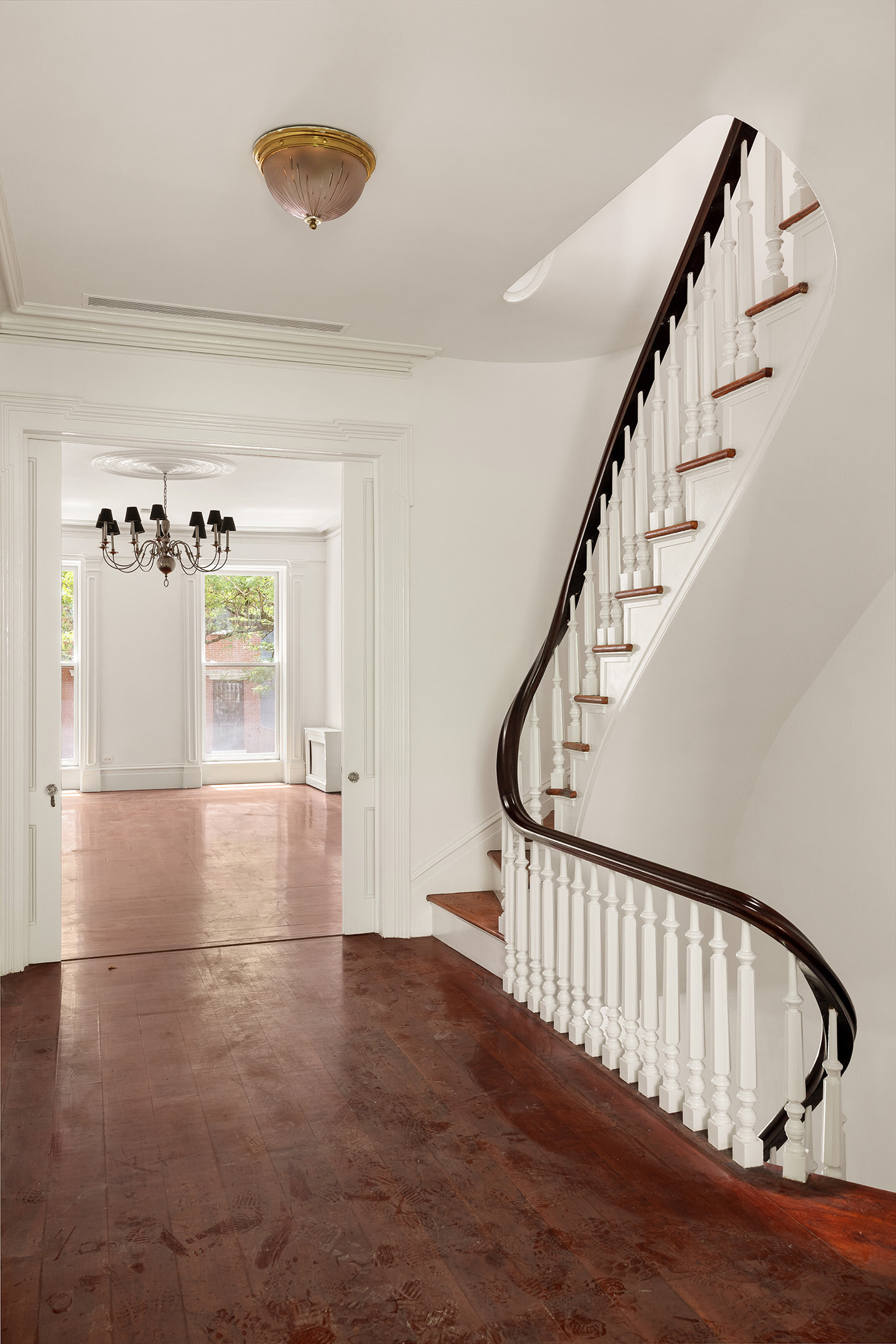225 West 22nd Street Manhattan, NY 10011 - Photo 6 of 12 a view of staircase with white walls and a window