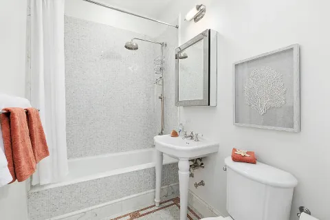 a bathroom with a sink toilet and shower