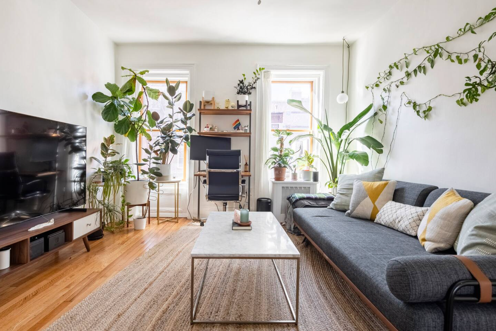 a living room with furniture fireplace and flat screen tv