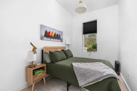 a bedroom with a bed and a window