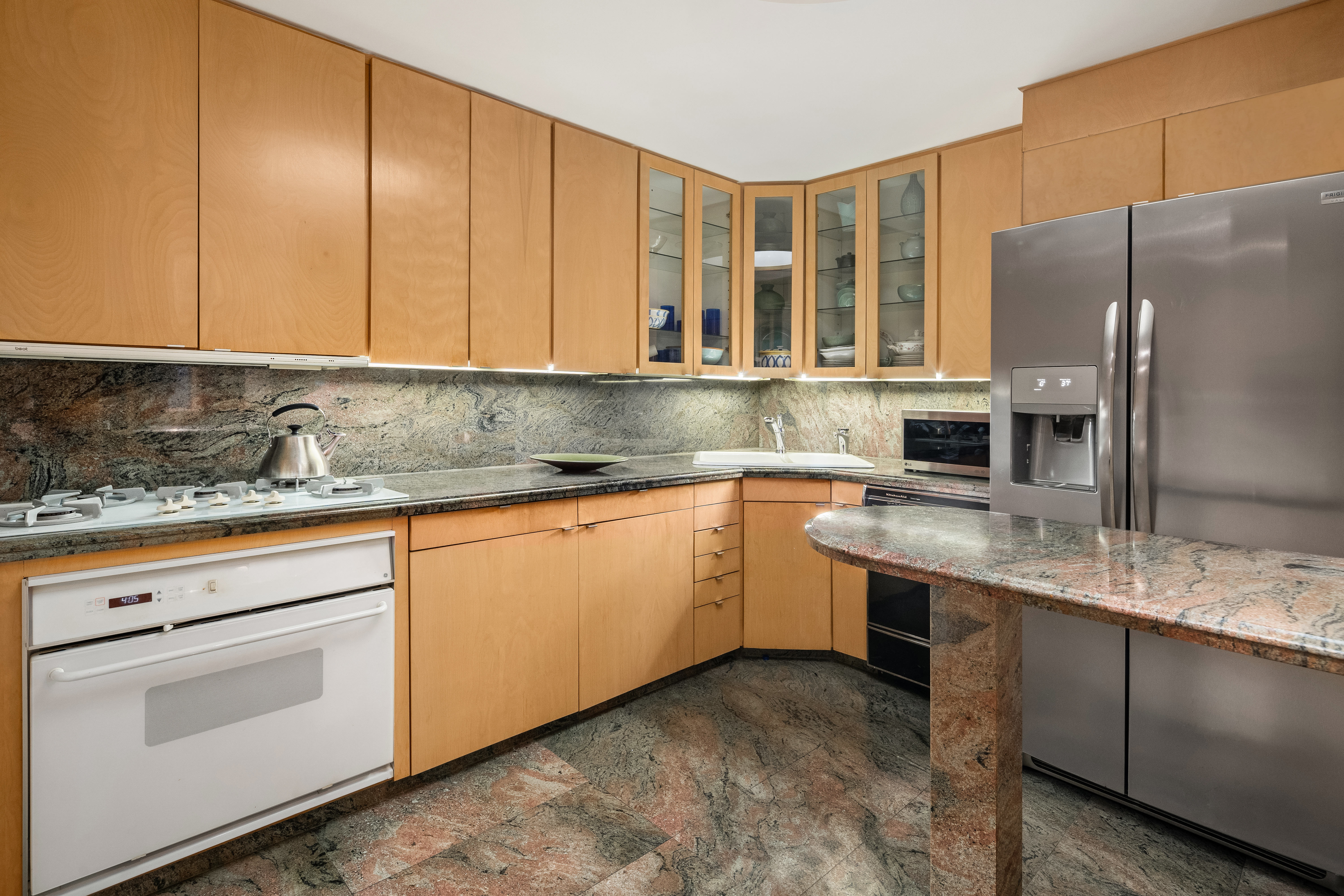 131 Mercer Street, Unit 2B Manhattan, NY 10012 - Photo 11 of 18 a kitchen with stainless steel appliances granite countertop a sink a stove and refrigerator