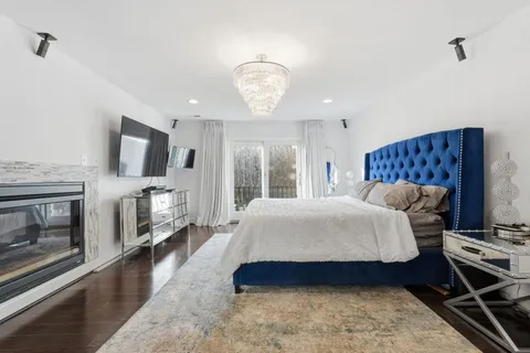 a spacious bedroom with a bed and a fireplace