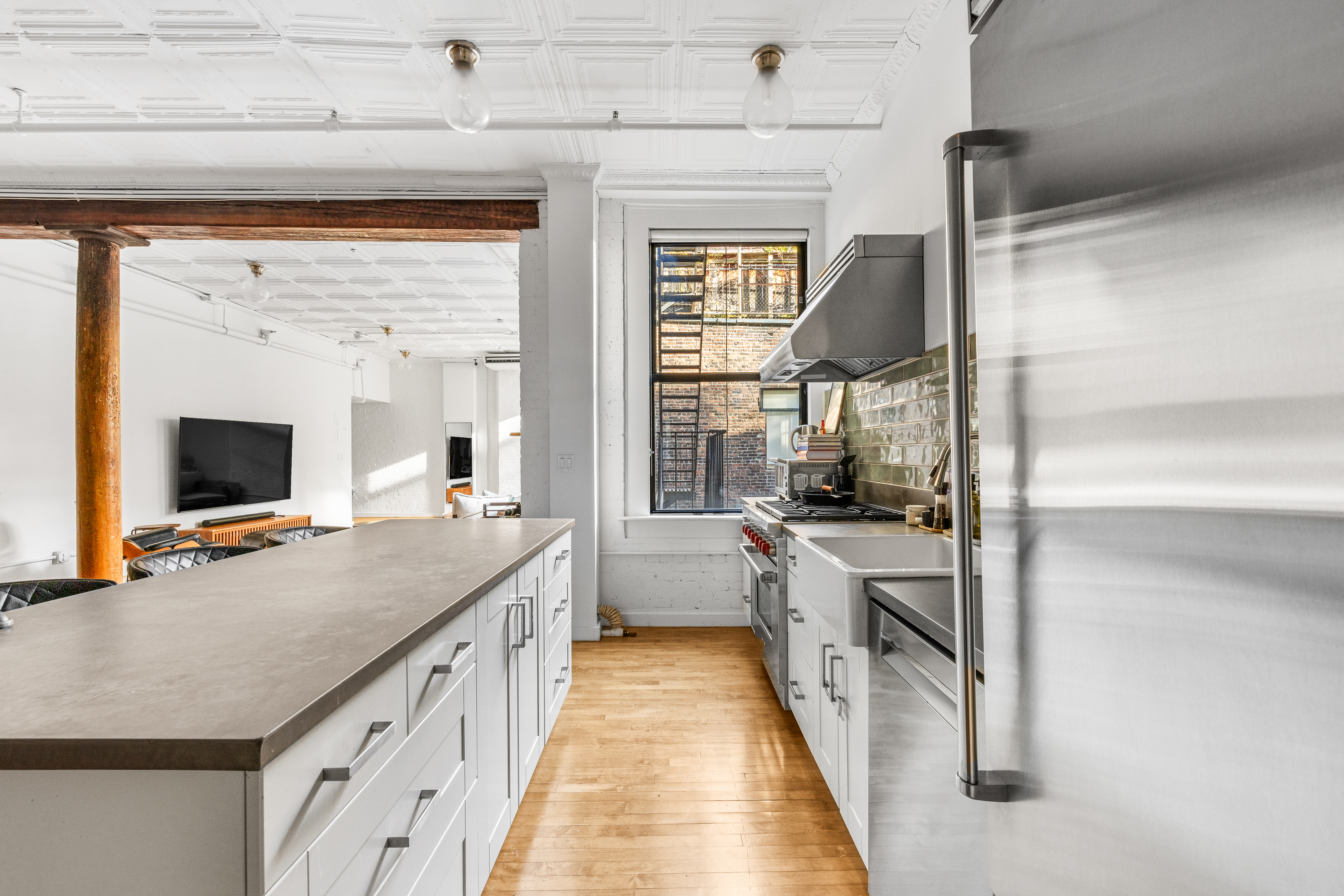 5 White Street, Unit 5B Manhattan, NY 10013 - Photo 6 of 21 a kitchen with sink stove and refrigerator