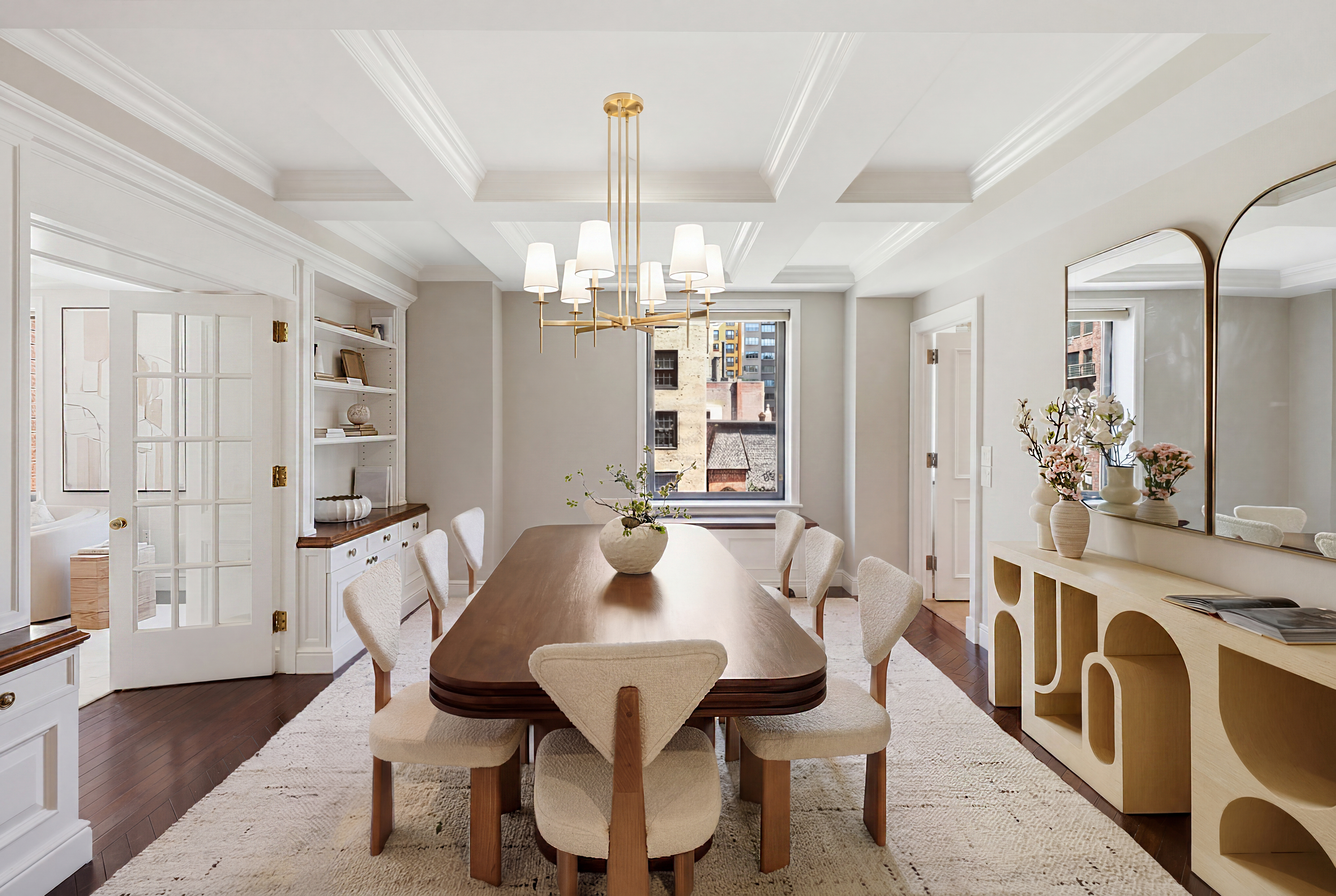 15 East 69th Street, Unit 7A Manhattan, NY 10021 - Photo 8 of 23 a view of a dining room with furniture and chandelier