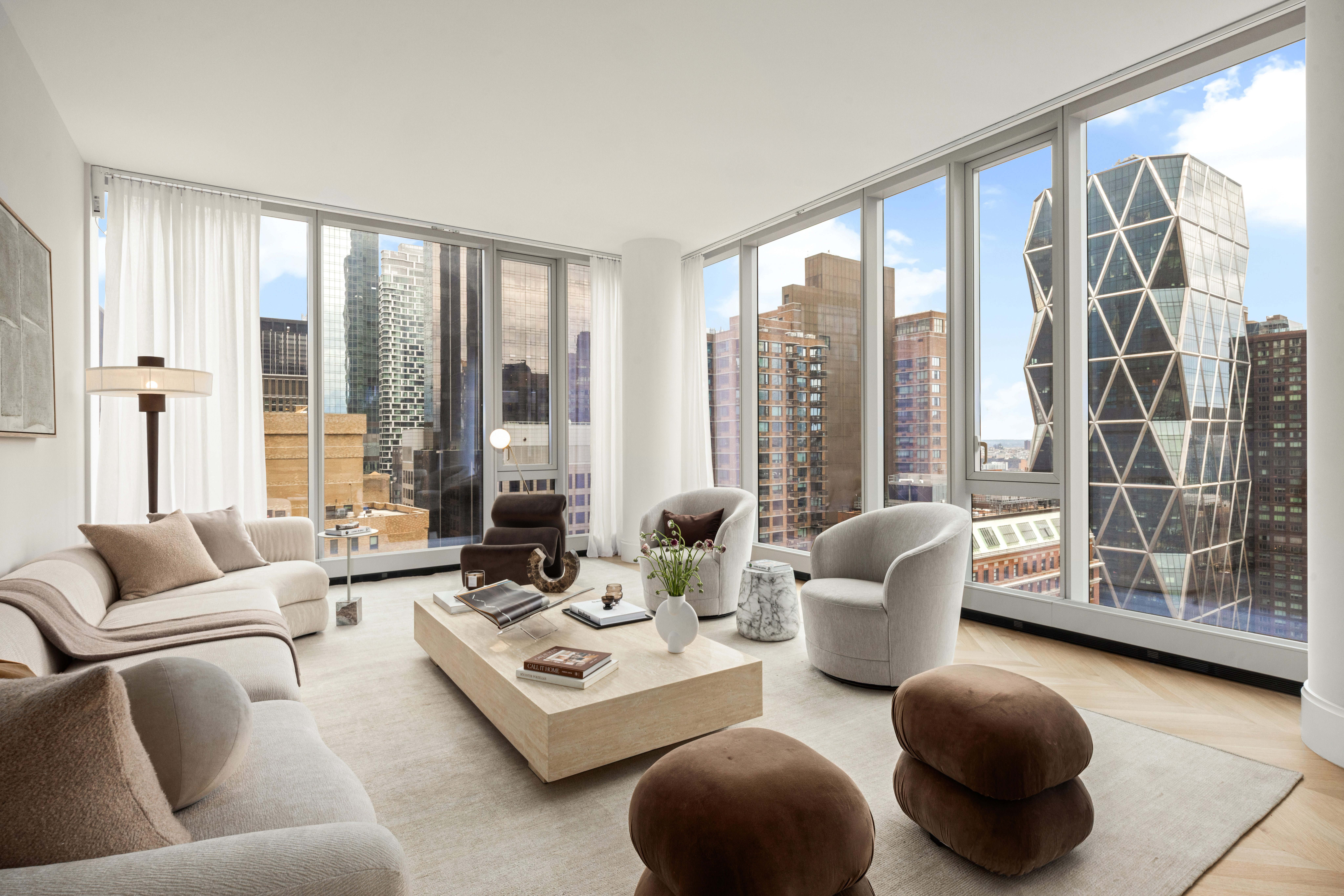 217 West 57th Street, Unit 34F Manhattan, NY 10019 - Photo 2 of 25 a living room with furniture and a floor to ceiling window
