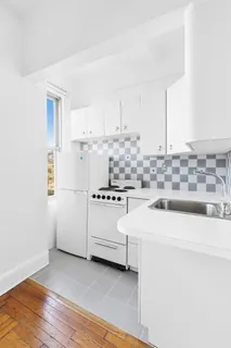 a kitchen with cabinets and white appliances