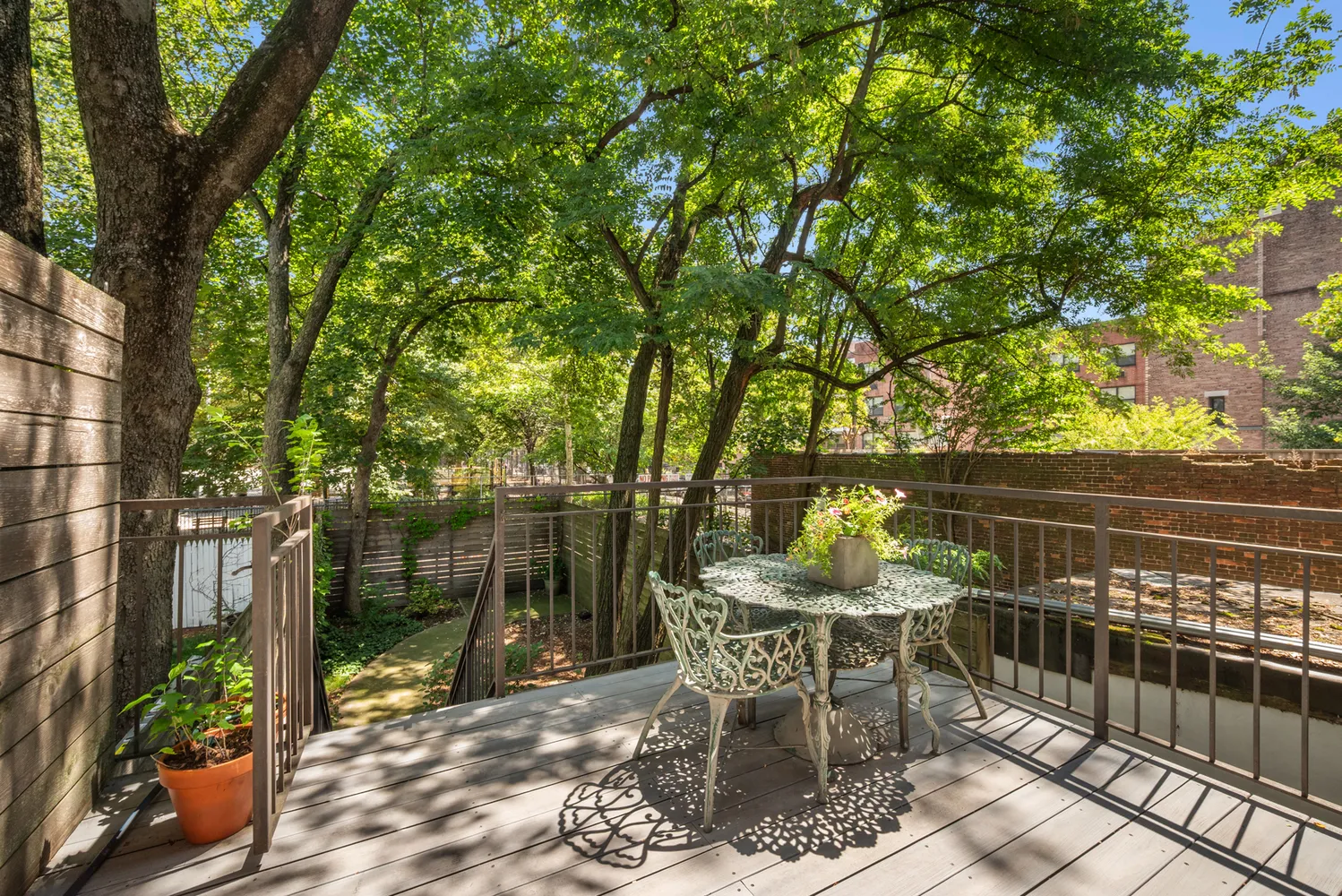 a patio with glass top table and chairs