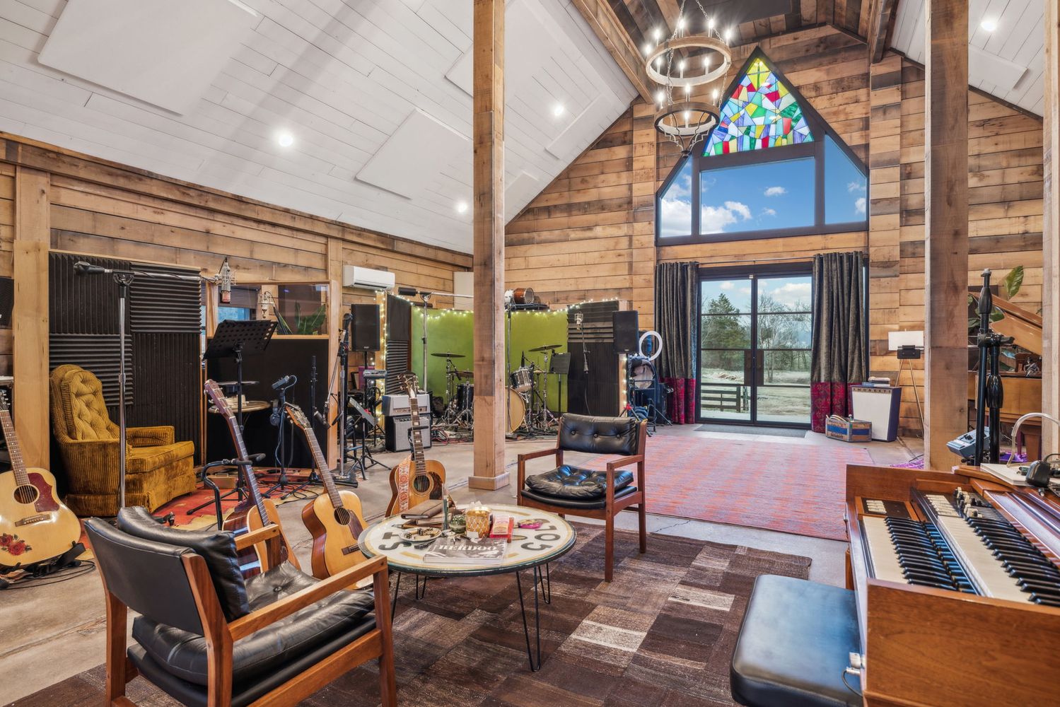 a living room with furniture a rug and a chandelier