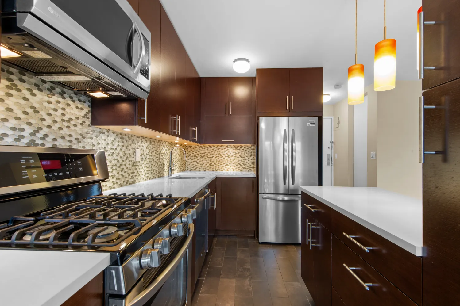 a kitchen with stainless steel appliances granite countertop a stove and a refrigerator