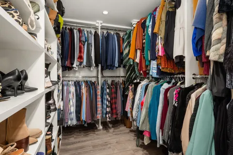 a view of walk in closet with clothes