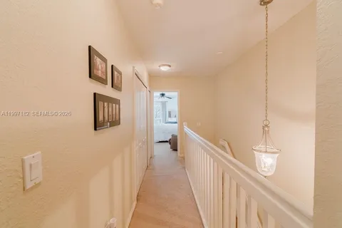 a view of a hallway with paintings on the wall