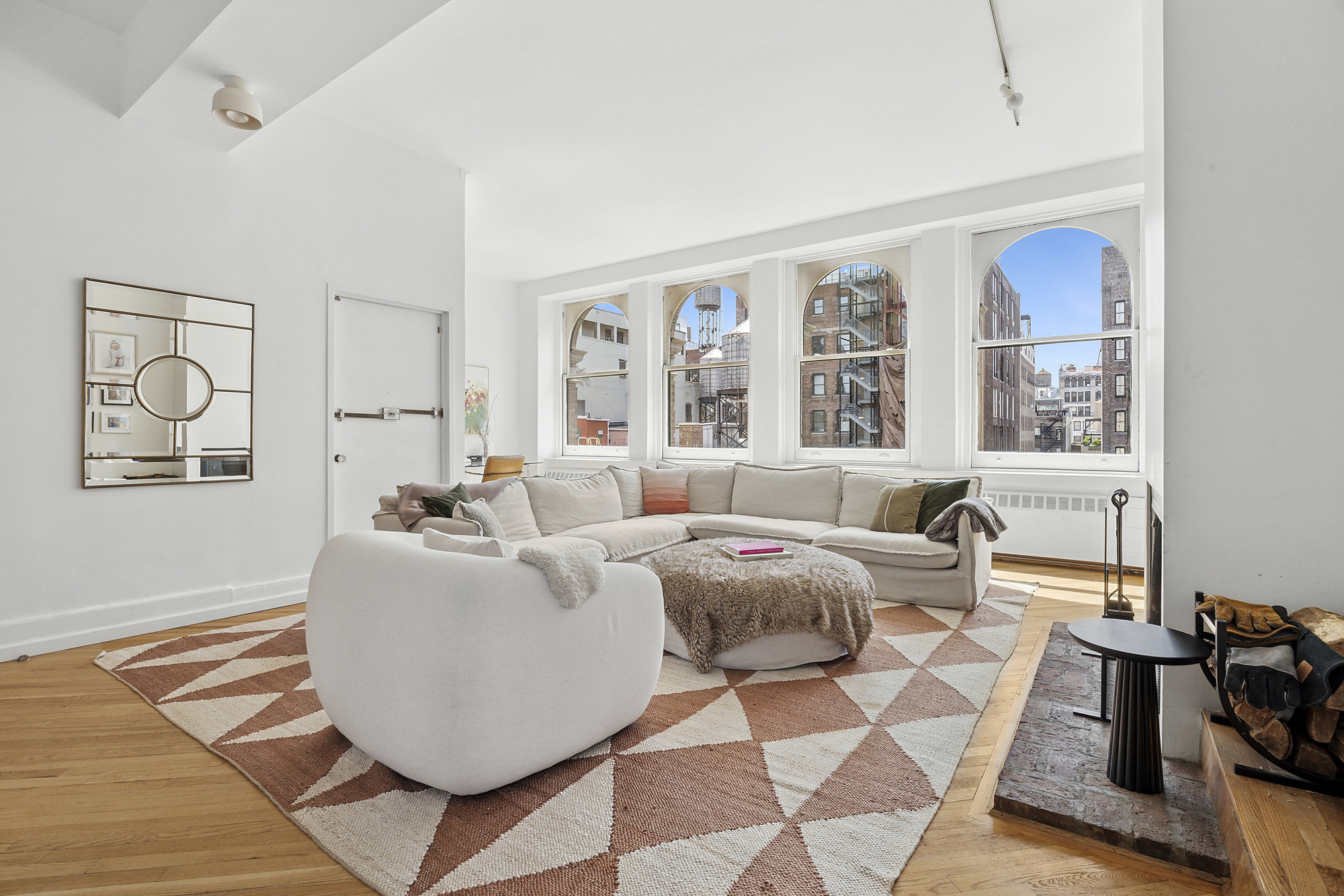35 East 12th Street, Unit 8C Manhattan, NY 10003 - Photo 3 of 22 a living room with furniture and painting on the wall with wooden floor