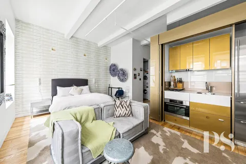a bedroom with a bed and a couch