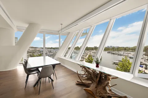 a living room with furniture and floor to ceiling windows