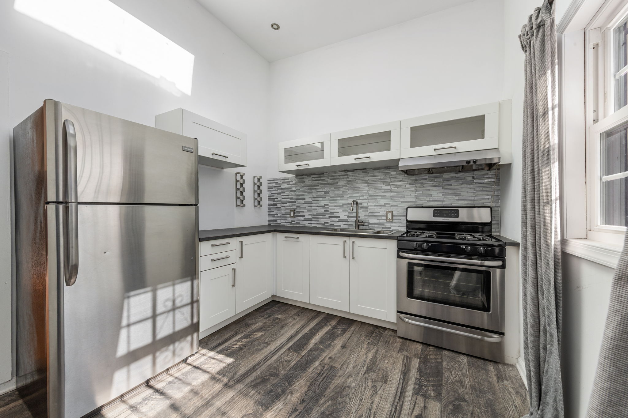 1218 Saint Marks Avenue Brooklyn, NY 11213 - Photo 17 of 42 a kitchen with stainless steel appliances granite countertop a refrigerator and a stove top oven