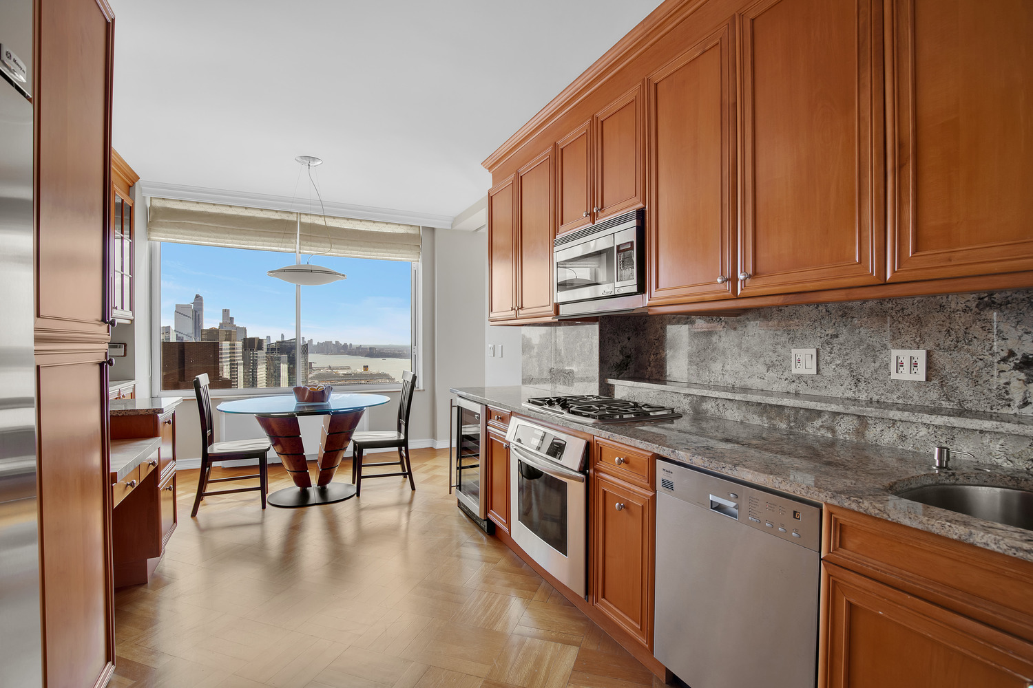 200 Riverside Boulevard, Unit 44A Manhattan, NY 10069 - Photo 6 of 22 a kitchen with stainless steel appliances granite countertop a stove a sink and a microwave