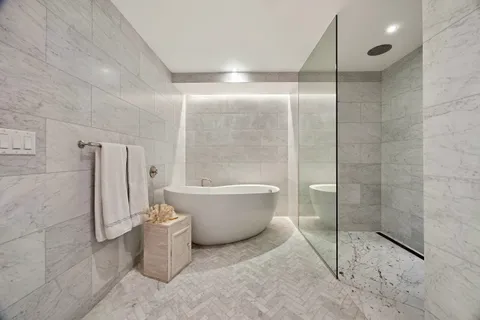 a bedroom with a bed and a chair