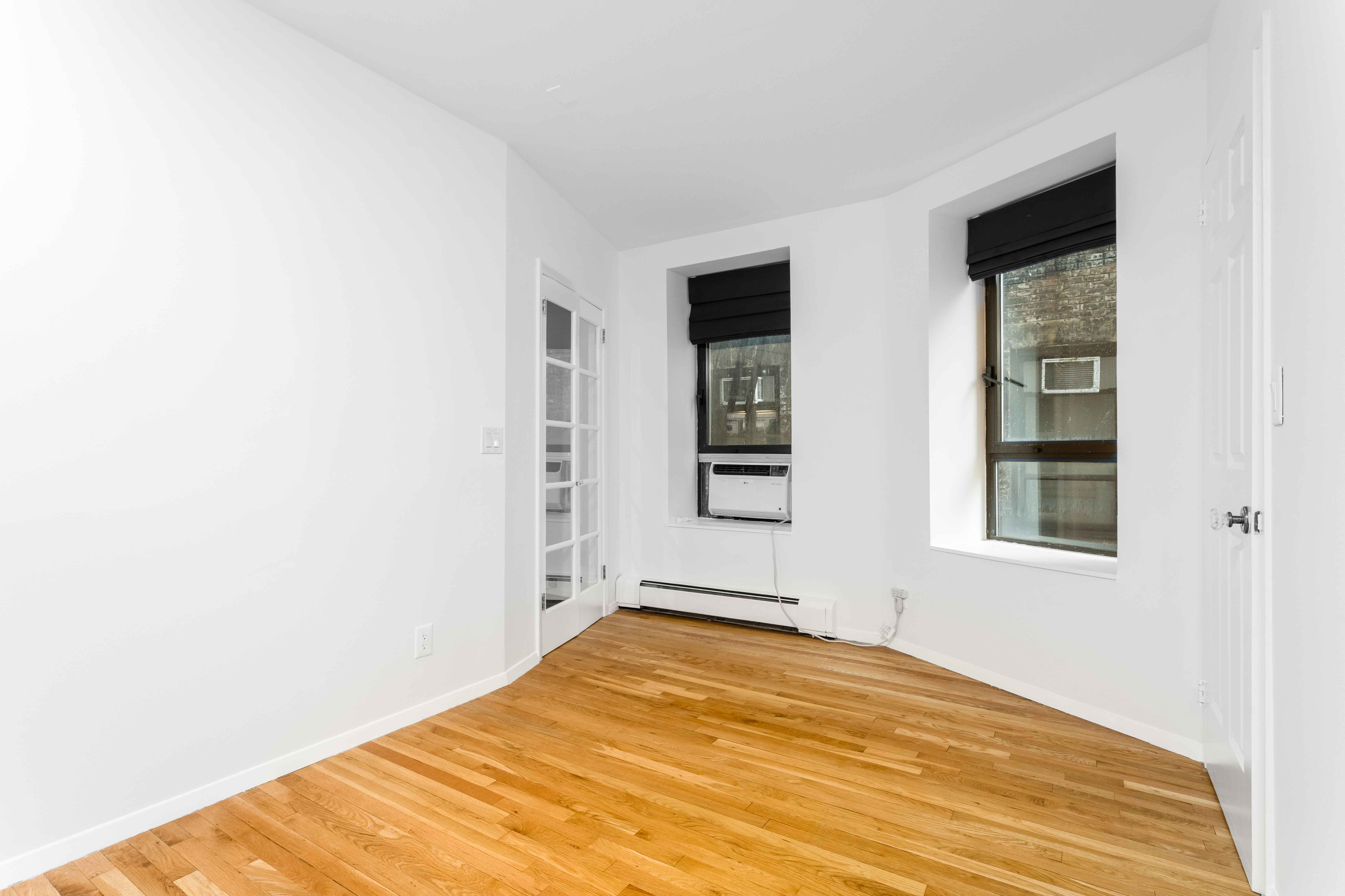 250 West 88th Street, Unit 408 Manhattan, NY 10024 - Photo 2 of 10 a view of empty room with wooden floor and fan