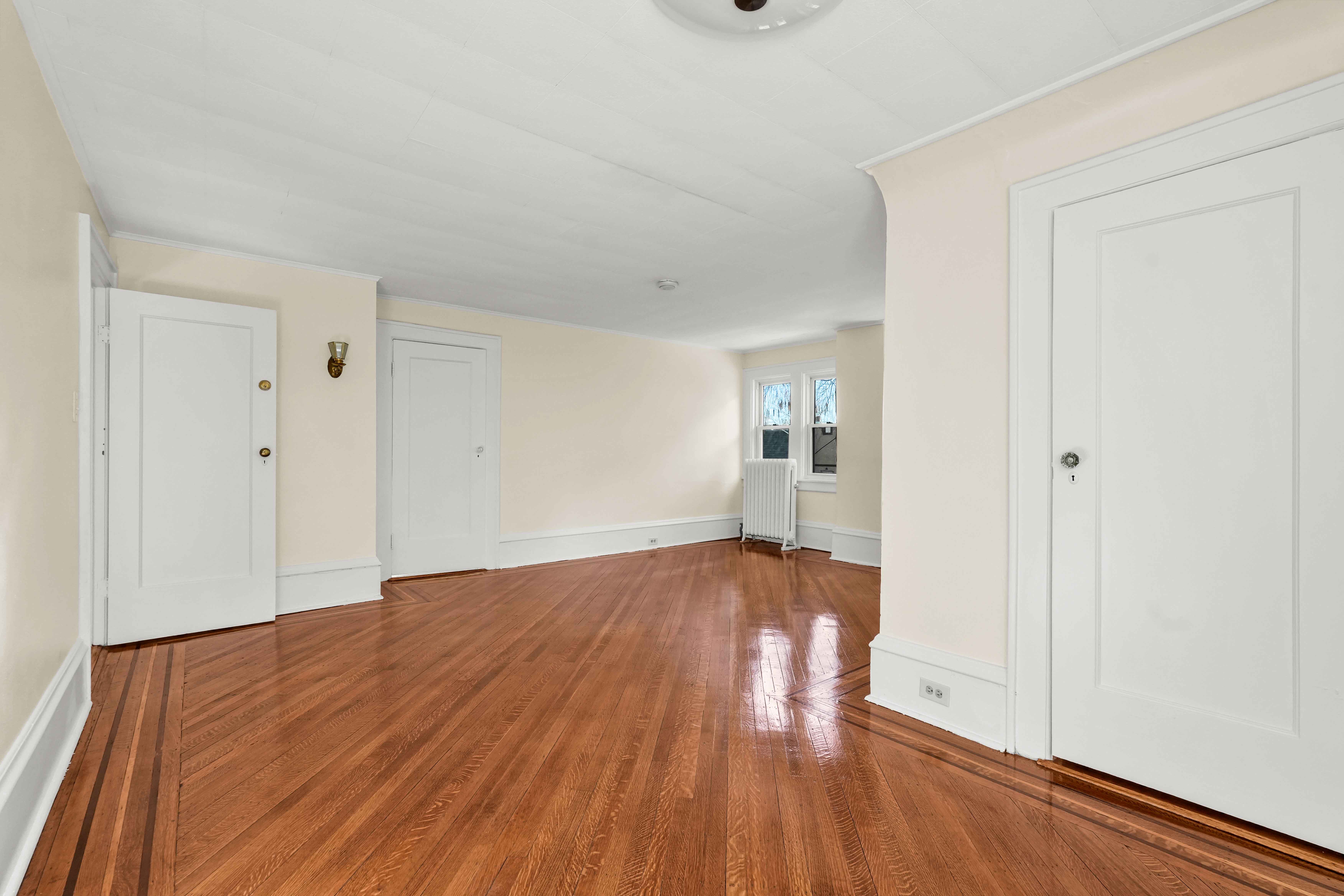 642 East 26th Street Brooklyn, NY 11210 - Photo 24 of 32 wooden floor in an empty room with a window