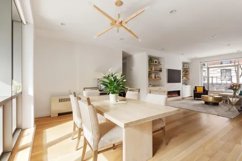 a view of a dining room with furniture and a chandelier