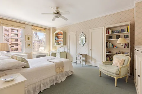 a bedroom with bed and a large window with the outer view