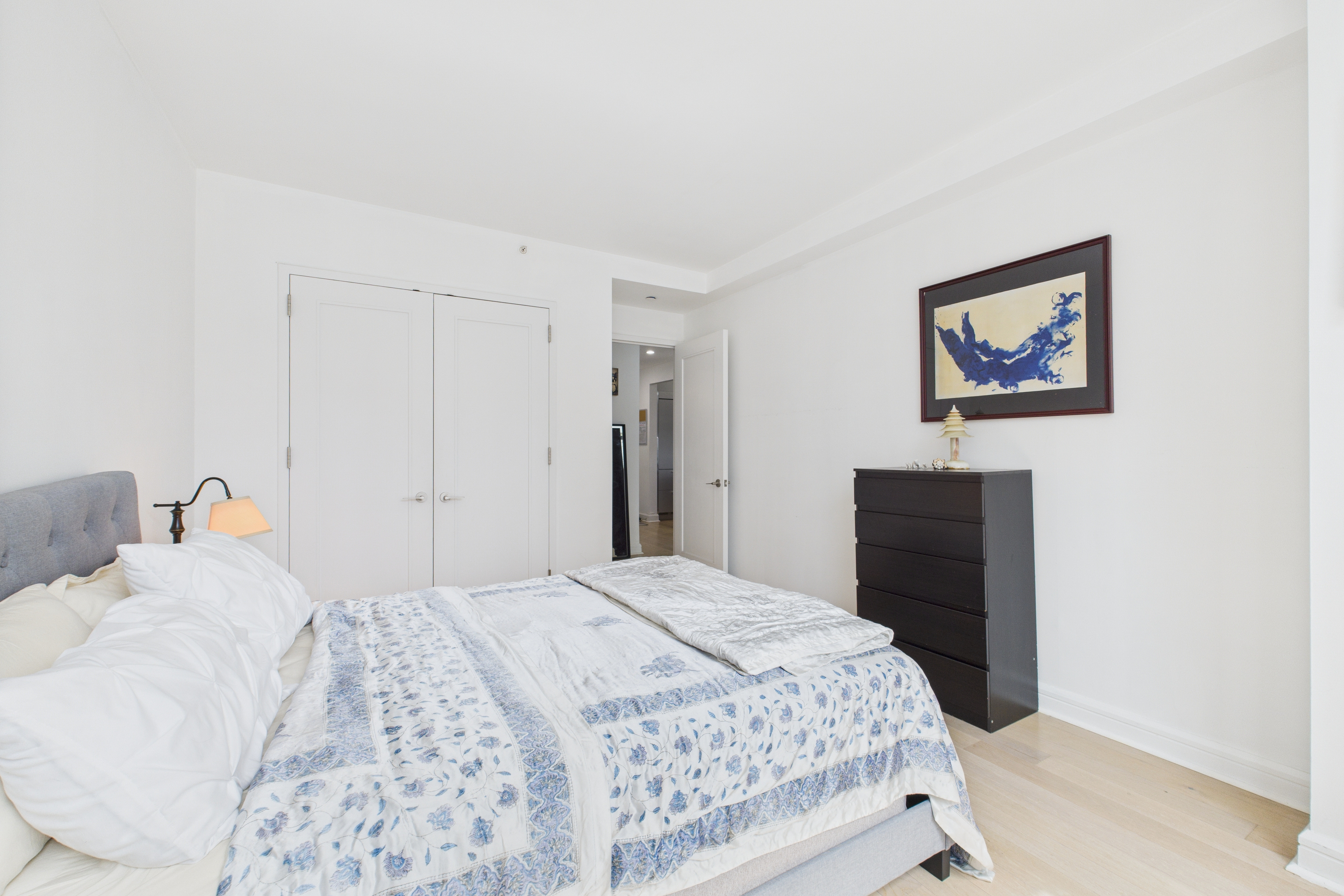 100 Riverside Boulevard, Unit 12B Manhattan, NY 10069 - Photo 8 of 10 a bedroom with a bed and a painting on the wall