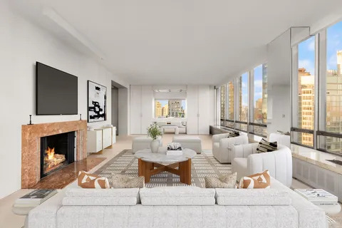 a living room with furniture fireplace and flat screen tv