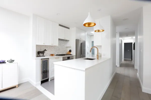 a kitchen that has a sink and a stove in it