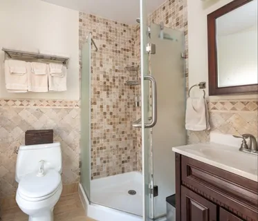 a bathroom with a sink a toilet and shower