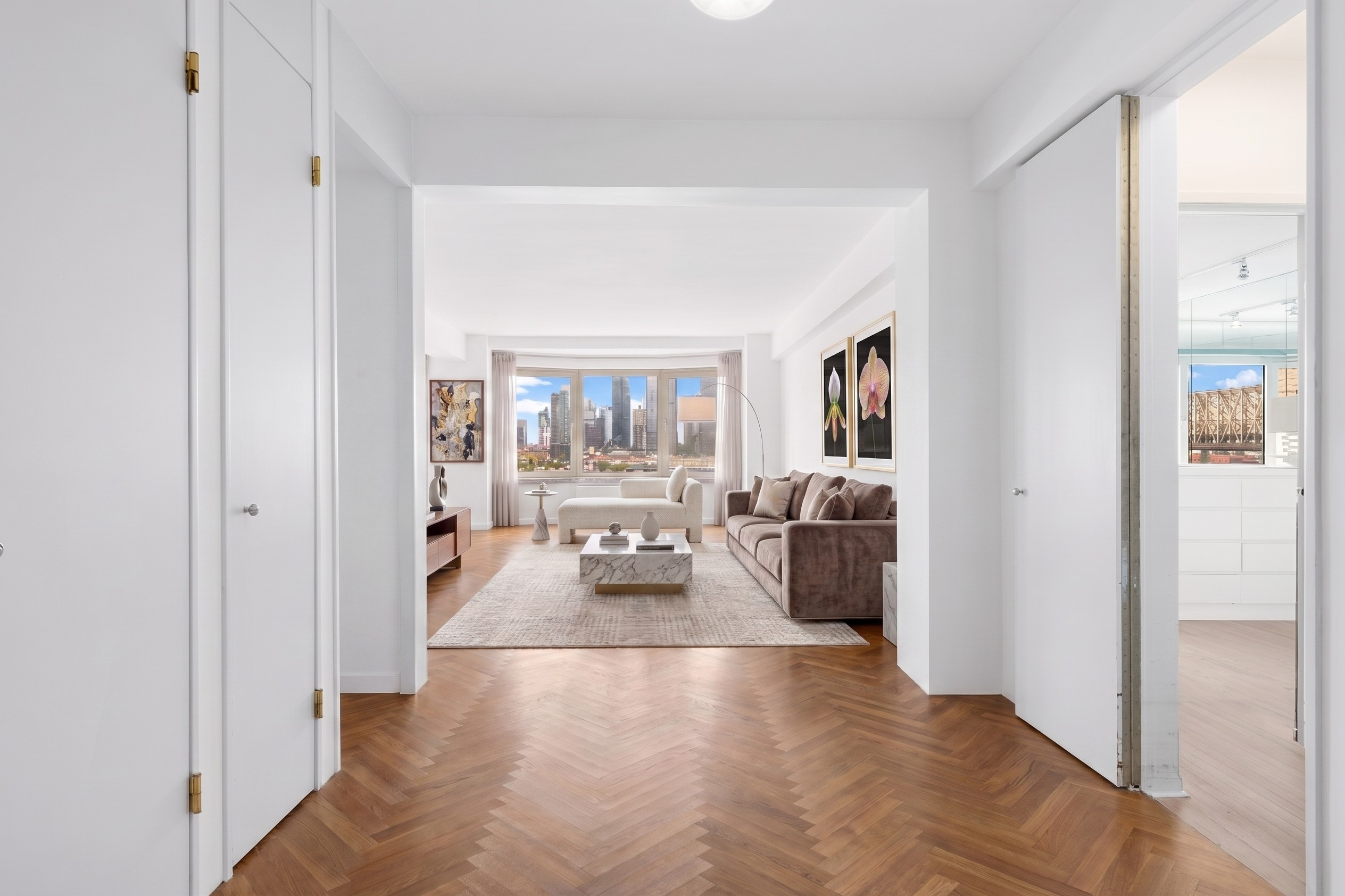 25 Sutton Place South, Unit 11M Manhattan, NY 10022 - Photo 3 of 10 a view of a living room with furniture and a flat screen tv
