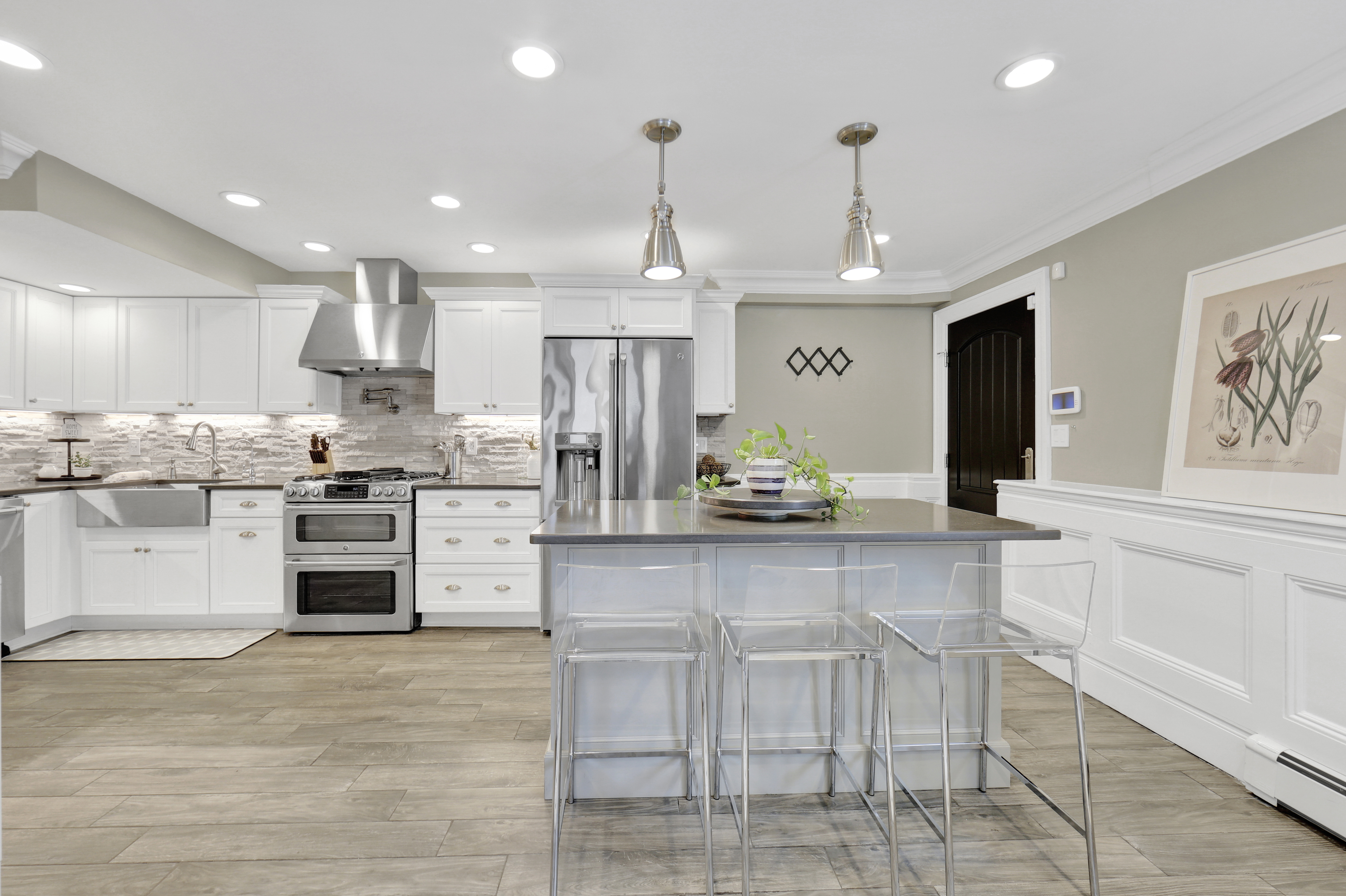 1-69 Beach 98th Street, Unit 1 Queens, NY 11694 - Photo 5 of 23 a kitchen with stainless steel appliances kitchen island granite countertop a stove and cabinets