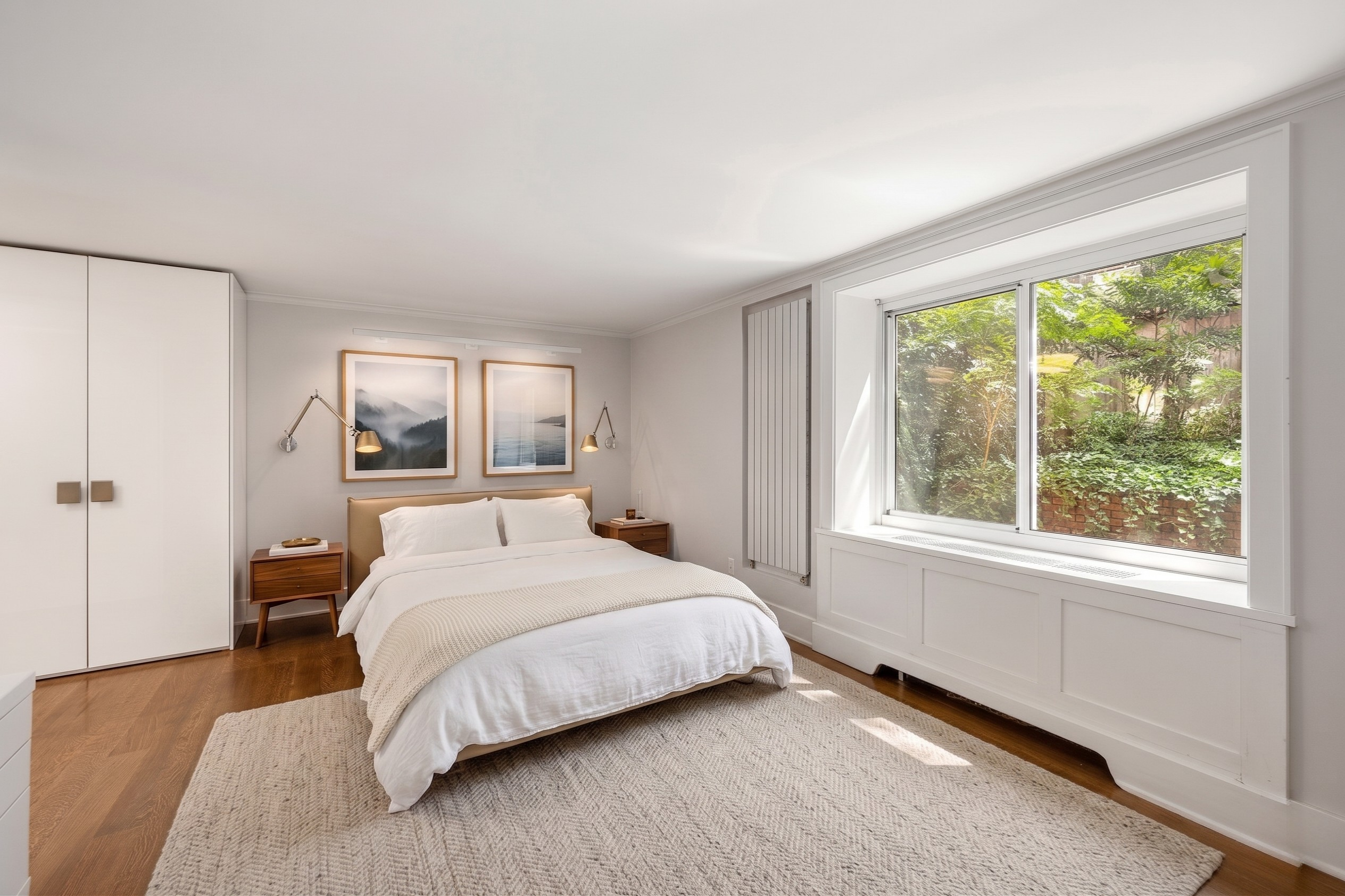 170 East 88th Street, Unit 1C Manhattan, NY 10128 - Photo 10 of 16 a bedroom with a bed and a large window