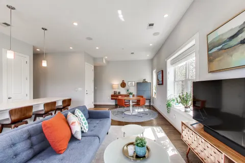 a living room with furniture and a flat screen tv