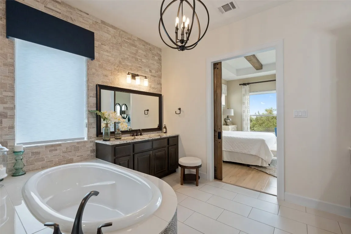 a bathroom with a tub sink and mirror