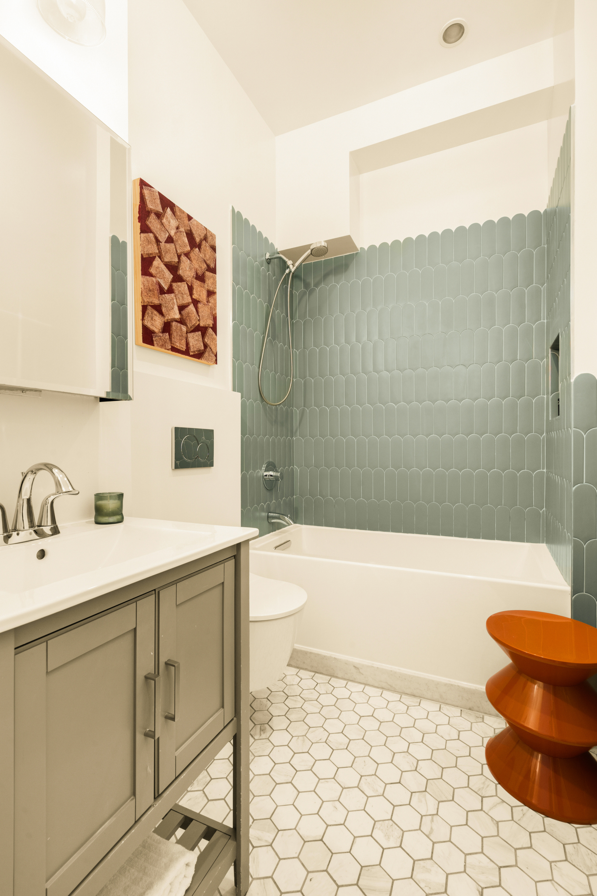 165 Perry Street, Unit 5A Manhattan, NY 10014 - Photo 12 of 14 a bathroom with a sink a toilet and bathtub
