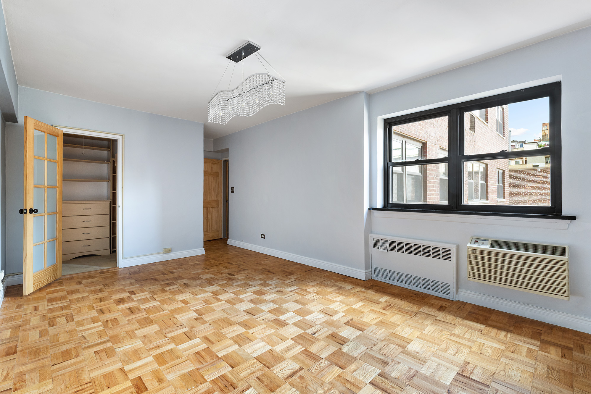 181 East 73rd Street, Unit 9G Manhattan, NY 10021 - Photo 8 of 17 a view of an empty room with a window