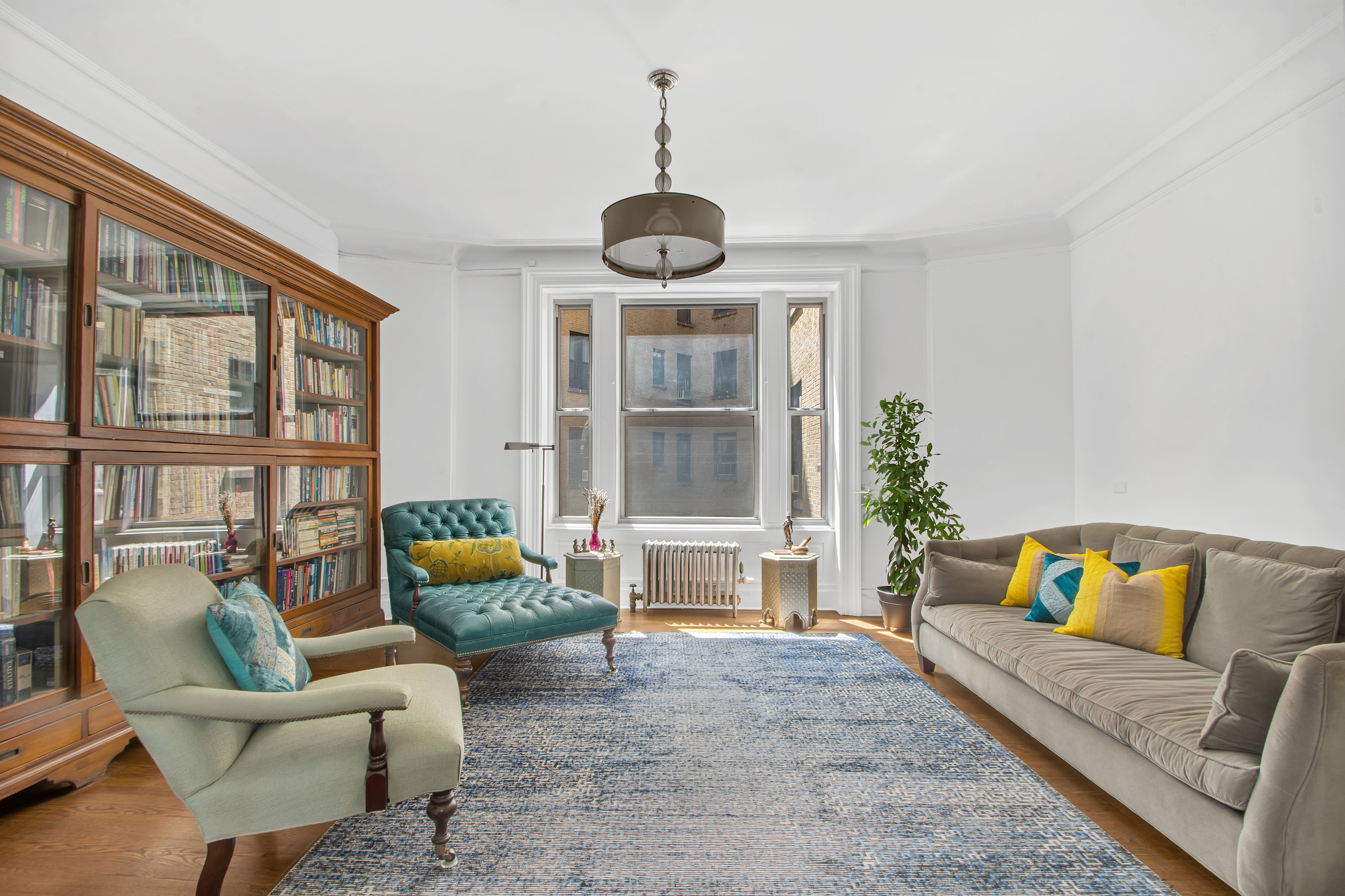 800 Riverside Drive, Unit 2E Manhattan, NY 10032 - Photo 4 of 27 a living room with furniture and a large window