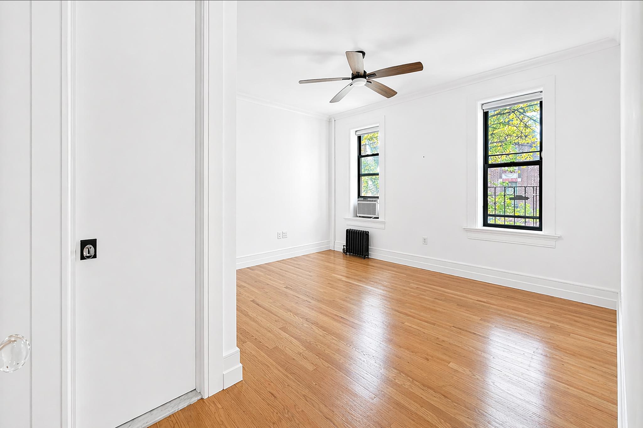 24-39 38th Street, Unit B10B9 Queens, NY 11103 - Photo 10 of 20 a view of empty room with wooden floor and fan