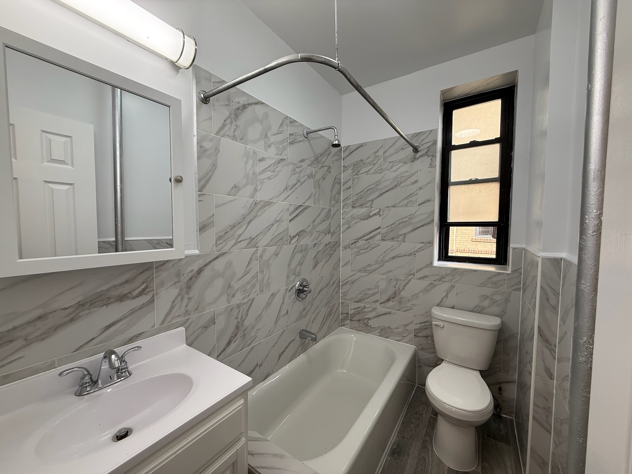 957 Greene Avenue, Unit BWEST Brooklyn, NY 11221 - Photo 7 of 8 a bathroom with a sink toilet and shower