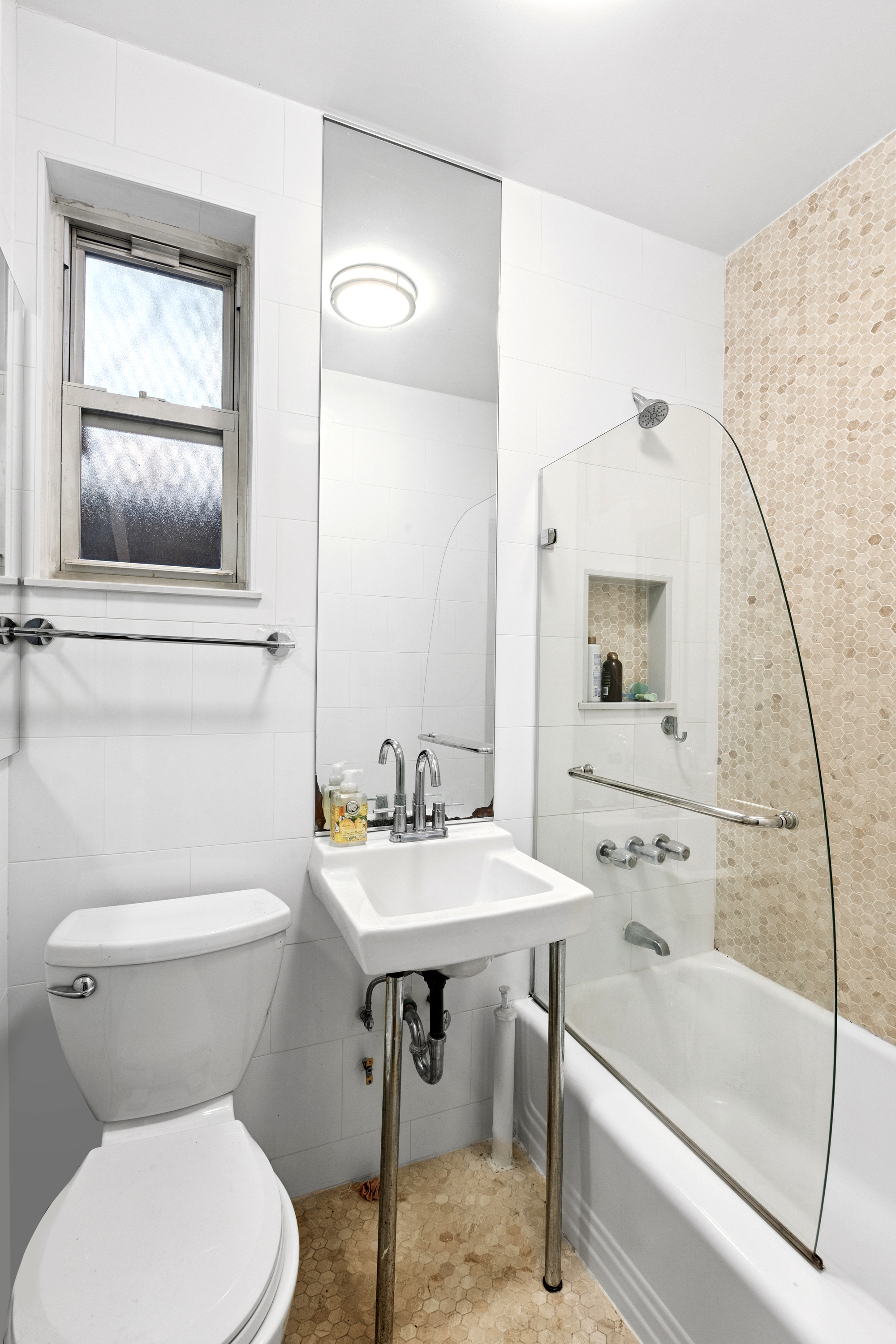 50 East 83rd Street, Unit 1R Manhattan, NY 10028 - Photo 9 of 12 a bathroom with a toilet sink and mirror