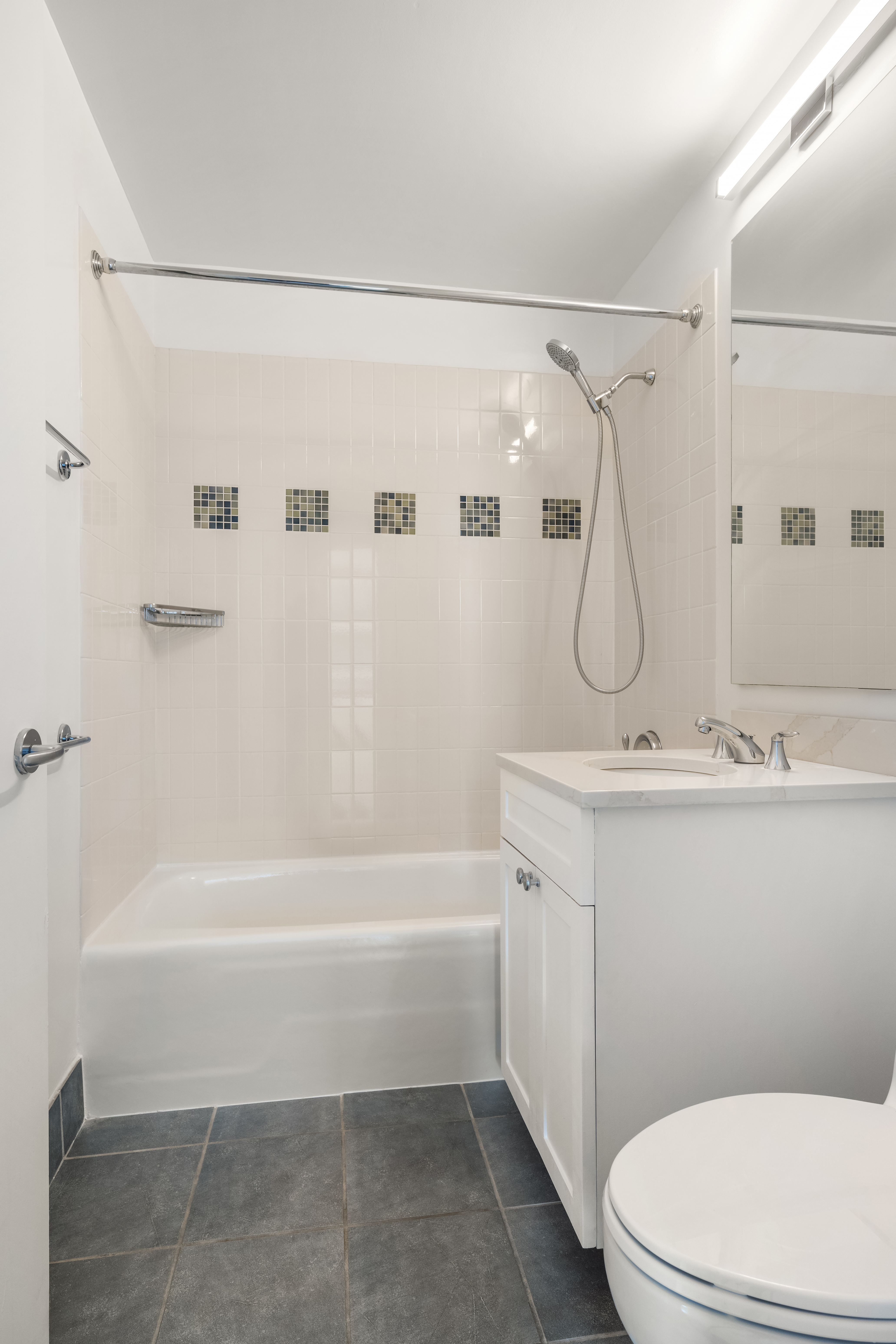 230 Ashland Place, Unit 19D Brooklyn, NY 11217 - Photo 6 of 11 a bathroom with a sink a toilet and a shower