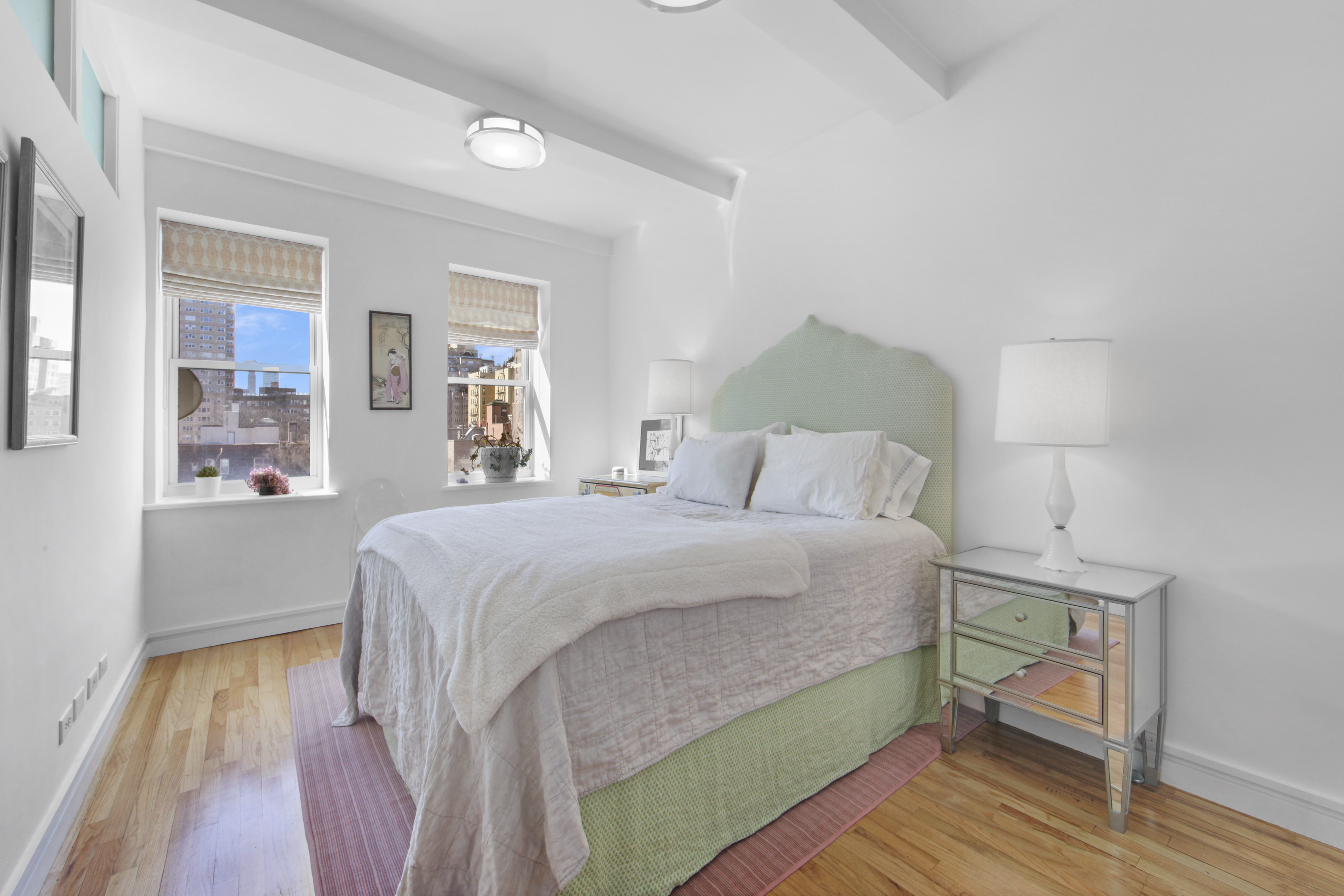 18 East 12th Street, Unit 7BC Manhattan, NY 10003 - Photo 16 of 26 a bedroom with a bed and wooden floor